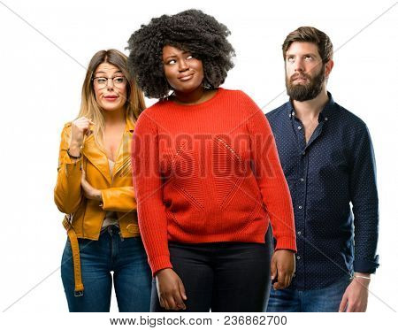 Group of three young men and women making funny face fooling