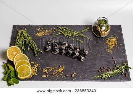 Black Corbiculas Lie On A Black Dish