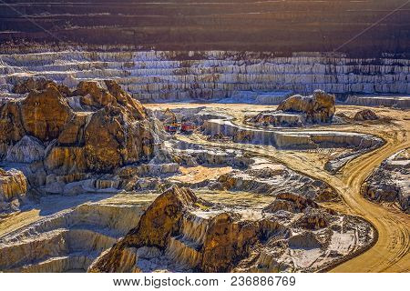 Excavator Loading Dump Truck With Raw Kaolin In Kaolin Open Pit Mine