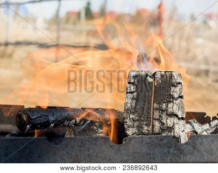 Fire From Burning Wood In The Grill Outdoors