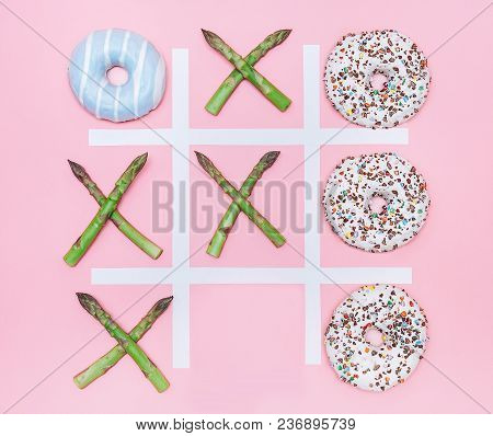 Tik Tak Toe Game With Donuts And Asparagus. Health Nutrition Concept Image