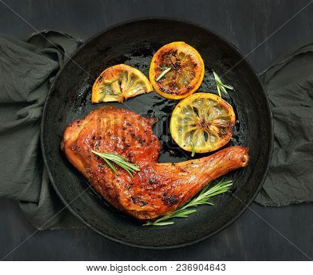 Barbecue Chicken Leg And Roasted Lemon In Frying Pan, Top View