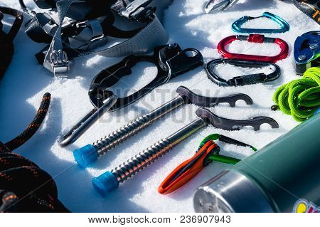 Close-up Of Winter Climbing Equipment On Fresh Snow On A Sunny Day. Carbines With A Rope Gazebo And 
