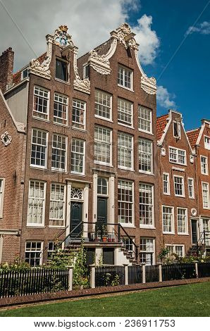 Semidetached Typical Houses And Green Garden At Begijnhof, A Medieval Semi-monastic Community In Ams