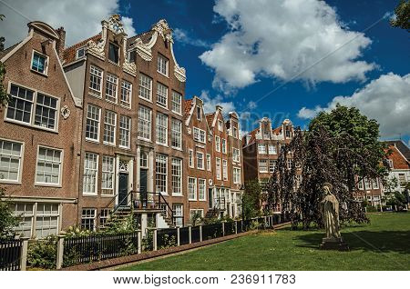 Semidetached Typical Houses And Green Garden At Begijnhof, A Medieval Semi-monastic Community In Ams