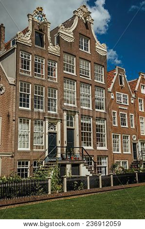 Semidetached Typical Houses And Green Garden At Begijnhof, A Medieval Semi-monastic Community In Ams