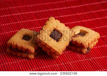 Stacked Chocolate Chip Cookies On Red Table