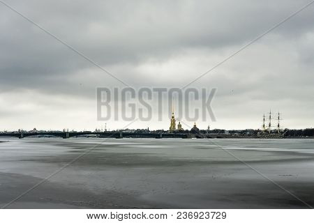 Frozen Spring Neva River In Cludy Day, Saint Petersburg, Russia. Peter And Paul Fortress On Backgrou