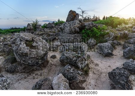 Magnificent Landscape Of Abstract Stones On A Hill At Sunset.