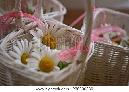 Wedding Flower Basket Filled With White Flowers And Pink Ribbins