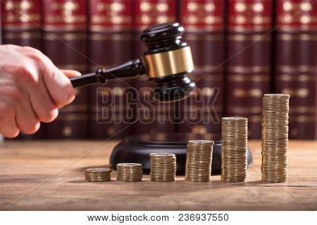Close-up Of A Judge's Hand Holding Gavel