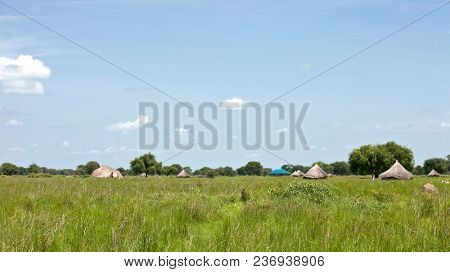 Village with grass huts on the plains of South Sudan.