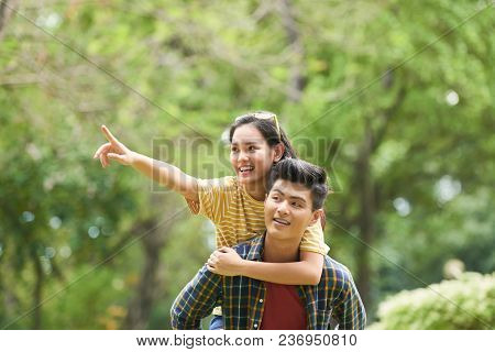 Joyful Young Asian Couple Spending Tme In The Park