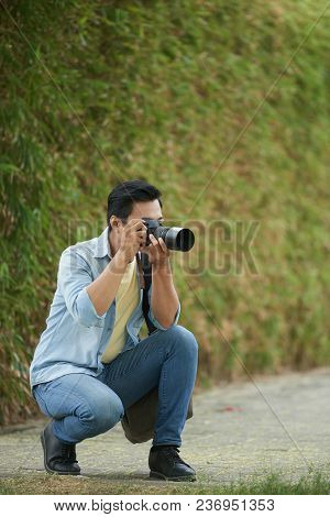 Professional Vietnamse Photographer With Digital Camera Photographing Nature