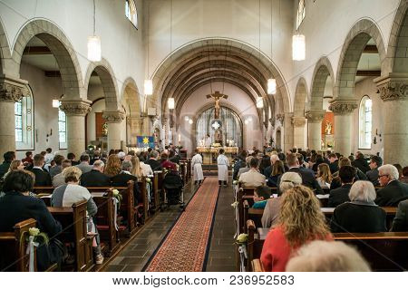Rieden Germany 15.04.2018 - Priest Holding Church Service In Front Of Crowd In Theinterior Of A Chur