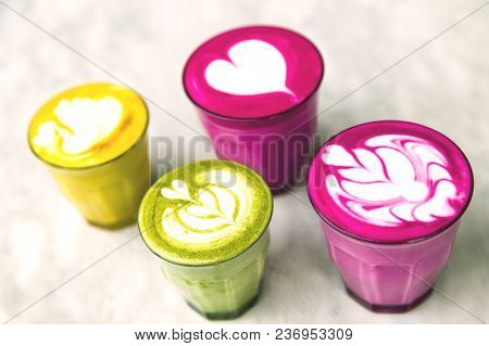 Beetroot, Matcha, Turmeric Lattes Are On The Marble Table With Art Floor On The Background, Trendy H