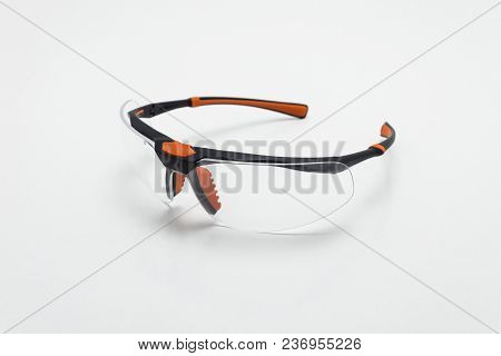 Safety Glasses In Black And Orange Color On White Background Isolation