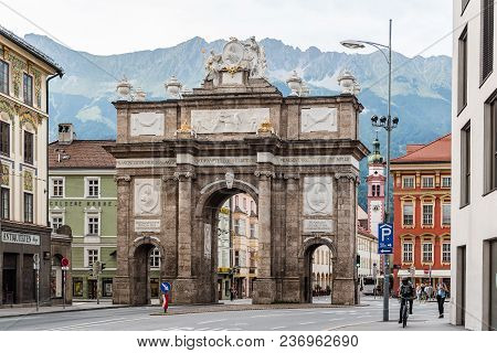 Innsbruck, Austria - August 9, 2017: Triumphal Arch Or Triumphpforte Against Mountains In Historic C