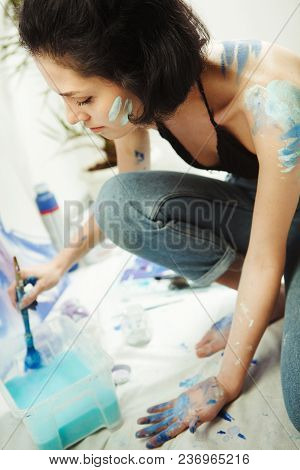 Woman Sits In Pofile And Works On Watercolor Painting. Art Therapy Painting Concept. Girl With Paint
