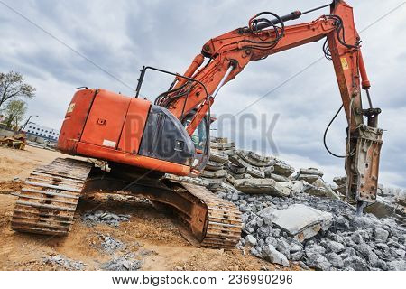 excavator loader machine at demolition with hydrohammer on construction site