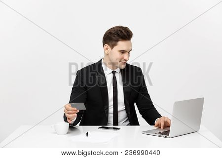 Young Businessman With Notebook And Credit Card Isolated Over White Background.