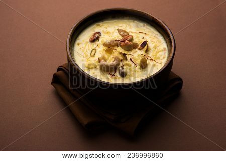 Kheer Or Rice Pudding Is An Indian Dessert In A Brown Terracotta Bowl With Dry Fruits Toppings