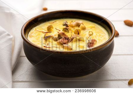 Kheer Or Rice Pudding Is An Indian Dessert In A Brown Terracotta Bowl With Dry Fruits Toppings