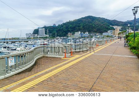 Atami, Japan - October 18, 2019: View Of The Beach Promenade, With Visitors, In Atami, Izu Peninsula