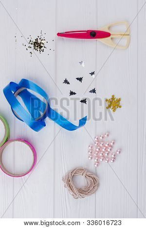 Wooden Background With Materials For Christmas Gifts Decoration. Diy Christmas Ornaments With Pearl 