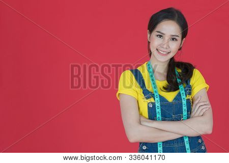 Verticle Image Of Portrait Shot Of Happy Beautiful Asian Female Fashion Designer Standing With Arms 