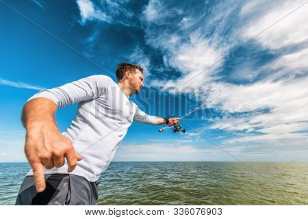 Fishing man in florida boat excursion tour throwing line with road fisherman in Everglases. Sports lifestyle.