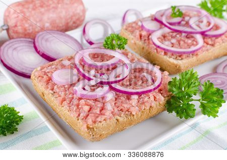 German Sandwich With Mett Ground Pork, Bun And Raw Meat With Onion And Parsley, Closeup