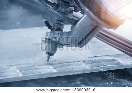 The Abrasive Multi-axis  Water Jet Machine Cutting The Aluminium Plate With Lighting Effect. The Hi-