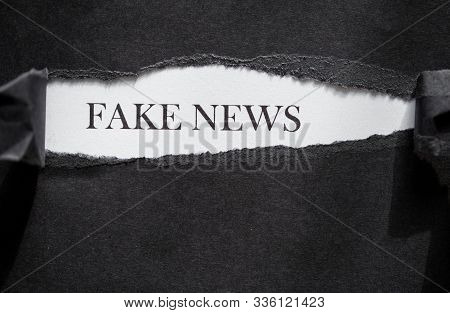 False News Printed On A White Background With Black Torn Paper.