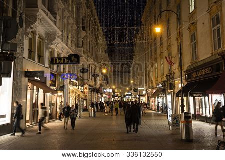 Vienna, Austria - November 6, 2019: Kohlmarkt Street, Crowded, At Night In Winter With Christmas Dec