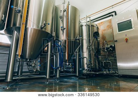 Microbrewery Equipment. Close Up Tanks In Brewery Warehouse. Metal Brewery Vessels. Small Business C