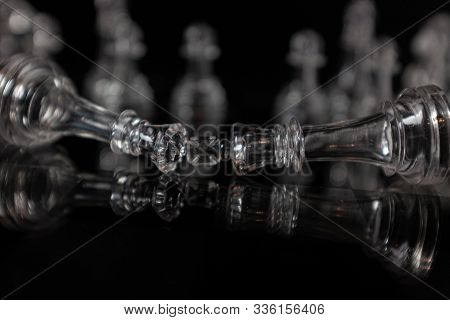 Fallen King And Queen. Transparent Methacrylate Chess Pieces On A Black Surface, King And Queen Fall