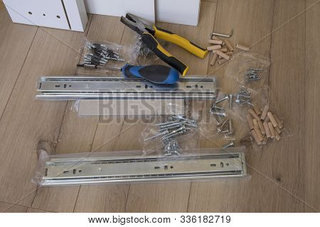 Furniture Assembly Parts And Tools For Self Assembly Furniture, On The Floor.