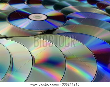 Background Texture: A Lot Of Computer Disks. Music Cds On A Black Background, Abstraction. Concept: