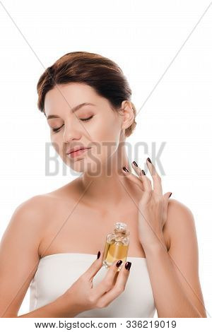 Cheerful Woman With Closed Eyes Apply Oil Perfume On Neck Isolated On White