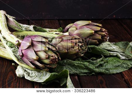 Artichokes On Rustic Background. Fresh Raw Organic Artichoke Flower.