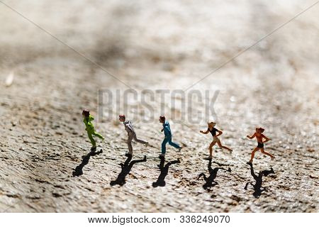 Miniature People : Group Of People Are Running  On Concrete Floor