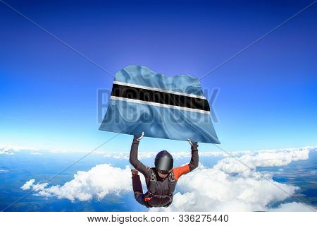 Botswana Extreme. Flag In Skydiving. People In Free Fall Grab Flag Of Botswana. Patriotism, Men And 