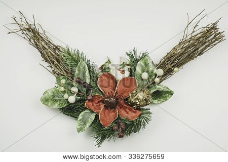Christmas Wreath Isolated On White Background. Big Red Flower And Green Leaves And Twigs.  Christmas