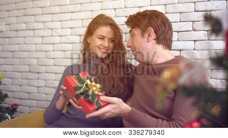 White Couple Exchange Presents For Holiday Season
