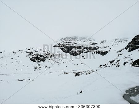 Panoramic View On Plateau In High Snowy Mountains Covered Snow At Sunny Spring Day. The Highroad, Sn