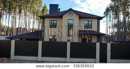 House With A Roof From A Bituminous Tile. Bituminous Tile For A Roof. A Roof From A Bituminous Tile.