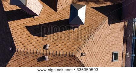 House With A Roof From A Bituminous Tile. Bituminous Tile For A Roof. A Roof From A Bituminous Tile.