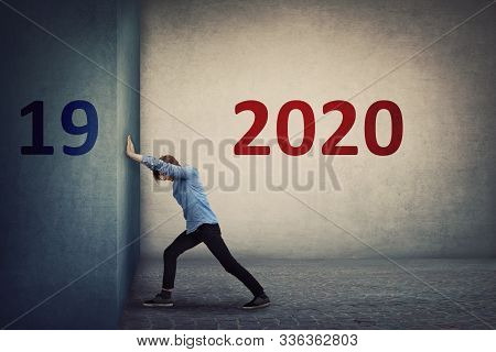 Conceptual Scene As A Confident Person Pushing The 2019 Old Wall To Make Space For The Coming New 20