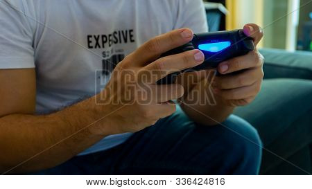 Istanbul, Turkey - November 2019: Man Holding A Sony Dual Shock For Sony Playstation Playing A Video